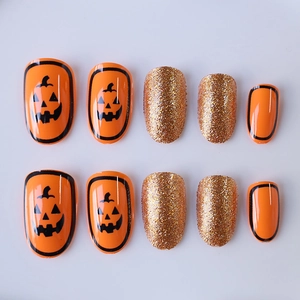 Short oval press-on nails with Halloween pumpkin patterns and gold glitter finish
