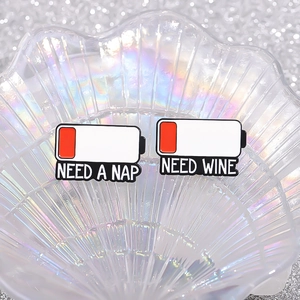 Creative battery low enamel pins featuring NEED A NAP and NEED WINE slogans on shell tray