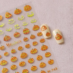 Halloween pumpkin nail stickers with metallic silver accents and themed nail display