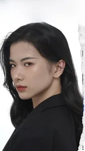 Close-up of triple-layer wavy silver ear cuff on model ear with polished metallic finish