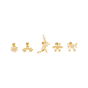 Set of five gold cubic zirconia stud earrings featuring floral, star, and butterfly shapes