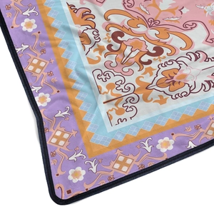 Floral flannel blanket with vintage patterns and black reinforced edges on white background