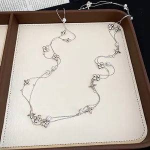 Elegant long silver necklace with sparkling flower charms and round zircon crystals
