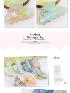 Detailed macro view of heart-shaped marble acetate hair claws with iridescent finish
