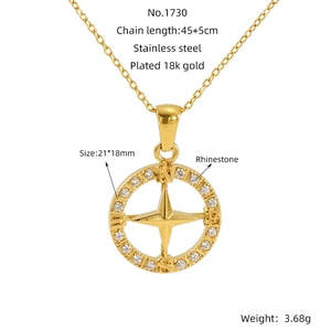 Detail of 18k gold plated compass pendant with rhinestones on a minimalist necklace