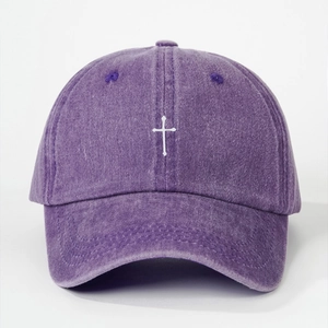 Macro detail of purple washed cotton baseball cap with white embroidered cross