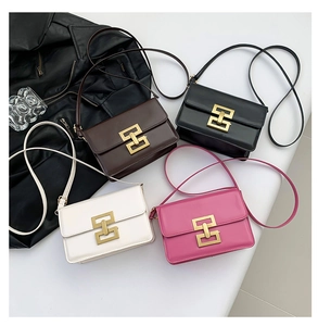 Flat lay of small crossbody bags in black, brown, white and rose red with gold locks