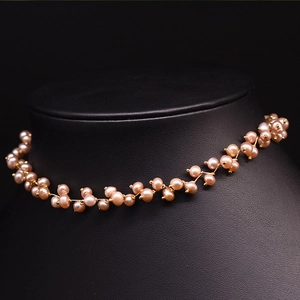 Detail of pink freshwater pearls on a gold-plated double-layer choker necklace