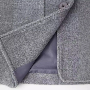 Classic grey wool coat with notch lapels and premium button details in a loose fit