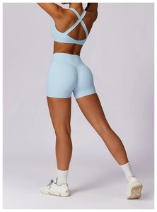 Detail of light blue yoga set with cross-back sports bra and high-waist shorts