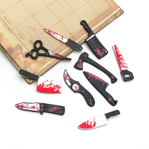 Detailed close-up of mini acrylic Halloween knives and tools with blood splatter decor