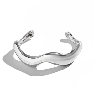 Detailed close-up of a silver irregular wave-shaped cuff bracelet for men on white background
