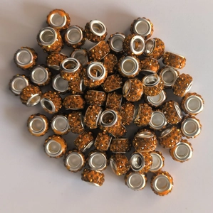 Close-up of orange rhinestone rondelle spacer beads with 5mm silver metal large hole