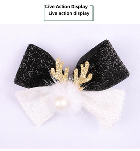 Detailed view of Christmas antler hair clip with sequins bow and fluffy white pompom