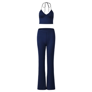 Detail of navy blue halter crop top and high waist flared trousers in elastic fabric