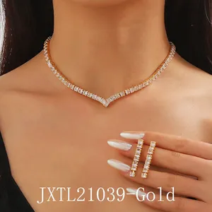 Close-up of a model wearing a gold V-shaped zircon necklace and matching long earrings