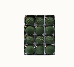 Close-up of 12 dark green Christmas tree balls in a clear box with diverse textures