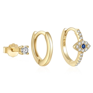 Macro shot of S925 sterling silver evil eye earrings set with gold finish and blue stones