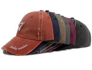 Detailed pile of washed cotton baseball caps with distressed edges and lucky number 7 embroidery
