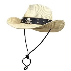 Detail of straw cowboy hat featuring black leather band and silver skull metal emblem