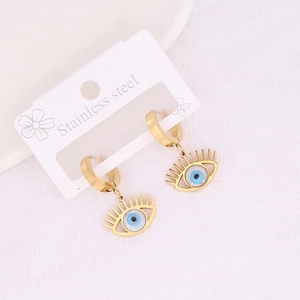 Golden stainless steel evil eye hoop earrings on white textured background