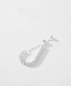 Macro detail of S925 silver ear cuff with zircon inlay and elegant chain ball pendant
