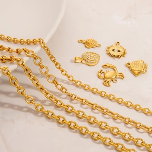 18K gold plated stainless steel coconut tree and sea shell charms necklace on marble