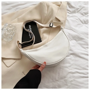 Detail of white nylon crescent bag with adjustable wide strap and minimal modern design