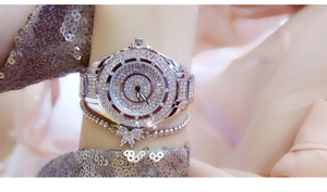 Close-up of luxury silver women's watch and bracelet set with sparkling rhinestones