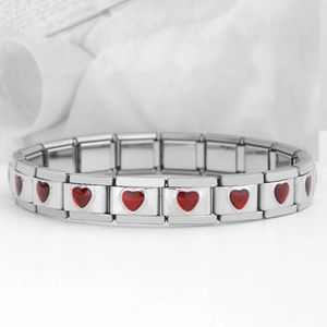 Detail of silver modular links with red heart-shaped gemstone charms for DIY bracelet