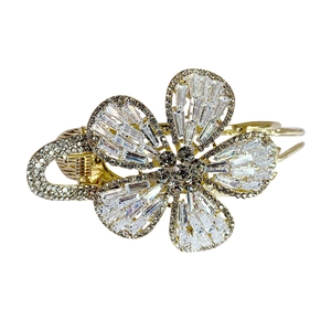 Elegant gold metal flower hair claw clip with sparkling zircon rhinestones on white background