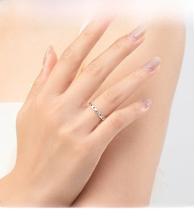 Macro shot of S925 sterling silver hollow star ring worn on a finger with soft lighting