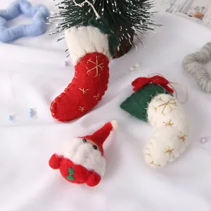 Handmade wool felt Christmas tree ornaments with Santa Claus and festive stockings