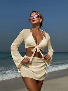 Dettaglio del set da spiaggia all'uncinetto crema con trama a rete e design stringato