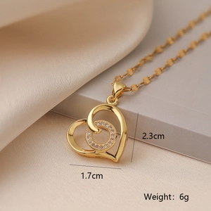 Detail view of 18K gold heart pendant with zircon circle and size dimensions shown