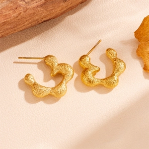Irregular gold flower stud earrings in matte stainless steel with an artistic petal design
