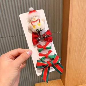 Detailed view of 5-piece Christmas hair clips set with snowman and reindeer on card