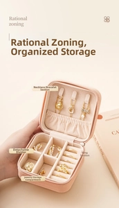 Close-up of pink PU leather jewelry box showing interior necklace hooks and ring slots