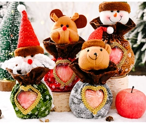 Detail of Christmas drawstring gift bags with heart window and cartoon plush figures