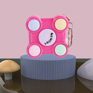 Pink mini portable memory game keychain with colorful buttons on a stylized blue base