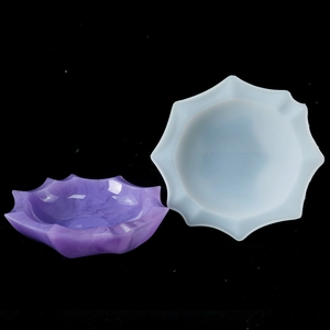 Detailed view of decagonal lotus silicone mold beside a finished purple resin storage tray
