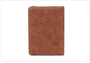 Close-up of brown pebbled leather passport holder with high-quality stitching details