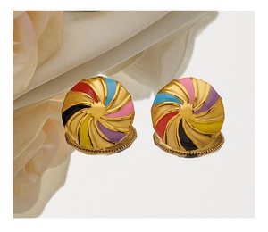 Detail of gold-plated stud earrings featuring colorful enamel swirl patterns on a smooth surface
