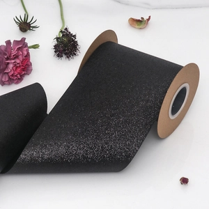 Glittery black decorative ribbon roll for Christmas gift wrapping and DIY crafts