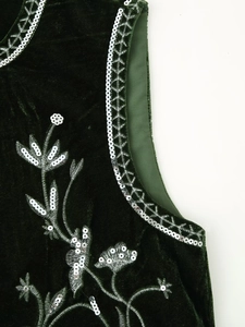 Close-up of silver sequin embroidery on premium dark green velvet fabric for women's vest
