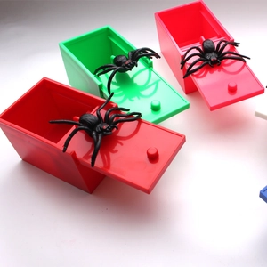 Three colorful prank boxes with realistic spiders inside for Halloween tricking