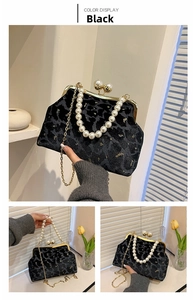 Close-up of black leopard print velvet shell bag with pearl handle and chain