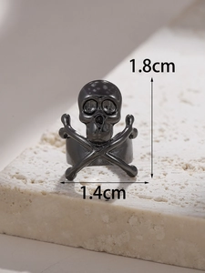 Macro shot of matte black skull ring with dimensional measurements 1.8cm by 1.4cm