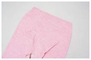 Detail of high-waisted heather pink yoga leggings showing elastic fabric and neat stitching