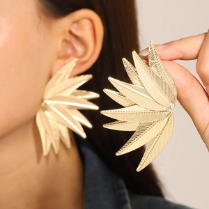 Chunky gold leaf drop earrings with textured metal finish for women in minimalist style